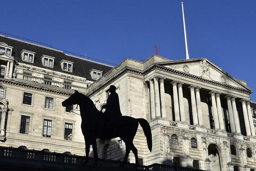 The Bank of England, seen with a statue in the foreground, in London on Dec 16, 2014. -- PHOTO: REUTERS