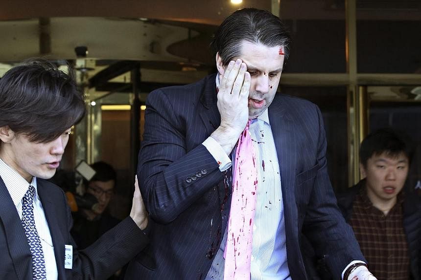 US Ambassador to South Korea Mark Lippert leaving Sejong Centre for Performing Arts in downtown Seoul on March 5, 2015, after being attacked by a knife-wielding assailant. -- PHOTO: EPA