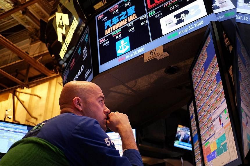 A trader at the New York Stock Exchange on Feb 6, 2015. The US economy continued to grow at a fairly moderate rate in recent weeks despite bad winter weather in some regions, according to a Federal Reserve report released on March 4, 2015. -- PHOTO: 