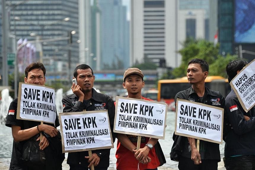 Workers display placards reading "Save KPK (Corruption Eradication Commission)" during a rally in Jakarta on Feb 6, 2015.&nbsp;Investment bankers and company executives are worried Indonesian President Joko Widodo's drive for clean governance is fall