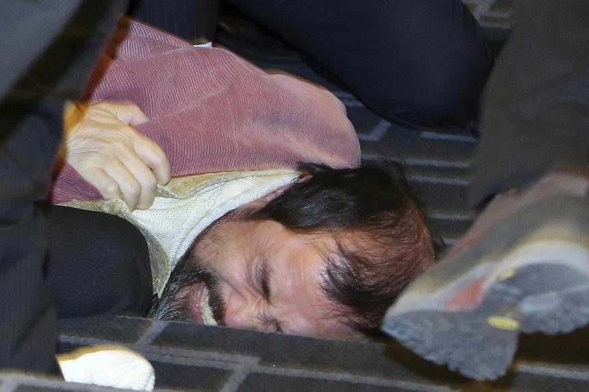 Security personnel detaining a man identified as 55-year-old Kim Ki Jong,&nbsp;who attacked the US ambassador to South Korea Mark Lippert at a public forum, in central Seoul on March 5, 2015. The US ambassador to South Korea was slashed in the face b