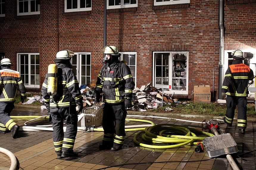 Firefighters outside German regional newspaper Hamburger Morgenpost in Hamburg, northern Germany, on Jan 11, 2015, following an arson attack.&nbsp;German police on Wednesday temporarily detained nine suspects over a January arson attack on a newspape