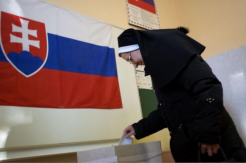 A woman casting her ballot during a referendum about same-sex marriage, a ban on gay and lesbian couples from adopting and sex education classes in schools, in Slovakia on Feb 7, 2015. Globalisation has served to curtail rather than expand school-bas