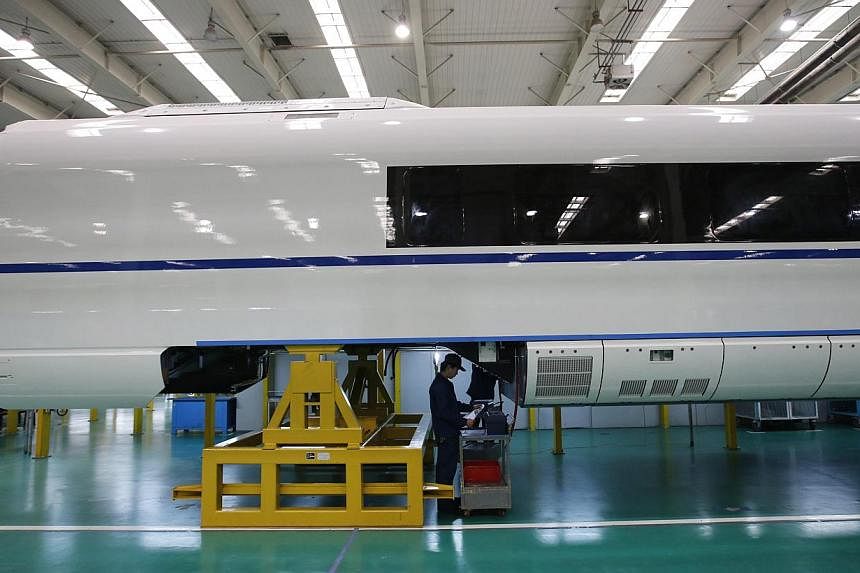 An employee works on a final assembly line for a high speed train model in Hebei.&nbsp;China announced its projected growth rate for 2015 at 7 per cent, after clocking the slowest growth in 24 years last year (at 7.4 per cent). As a result, much is r