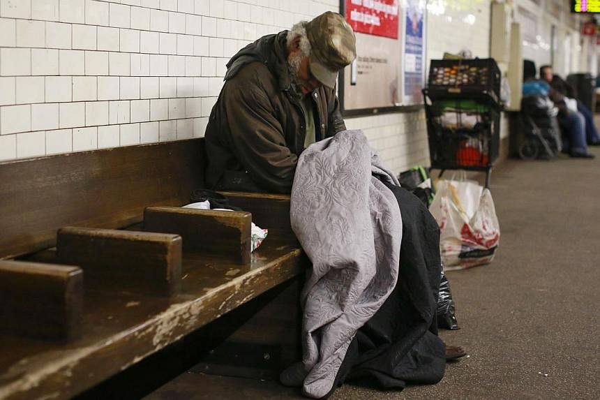 A man sleeping at at the Borough Hall subway station in the Brooklyn borough of New York on Feb 10. -- PHOTO: REUTERS