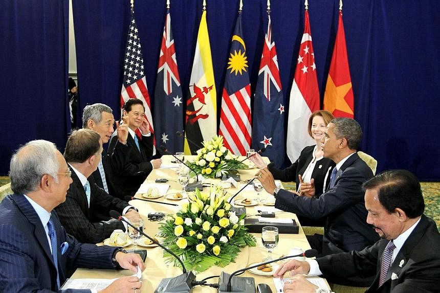 A 2012 photo from Singapore Prime Minister Lee Hsien Loong’s Facebook page shows Asia-Pacific leaders in Cambodia discussing the Trans-Pacific Partnership with US President Barack Obama (second from right). -- PHOTO: MINISTRY OF COMMUNICATIONS AND 