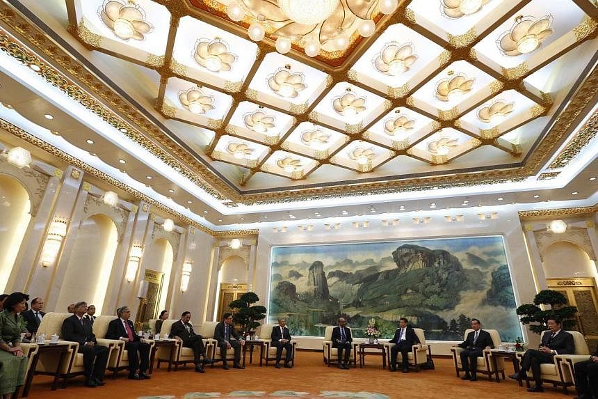 China's President Xi Jinping (fourth right) meets with guests at the Asian Infrastructure Investment Bank (AIIB) launch ceremony at the Great Hall of the People in Beijing in this Oct 24, 2014 file photograph. Britain says it has sought to become a f