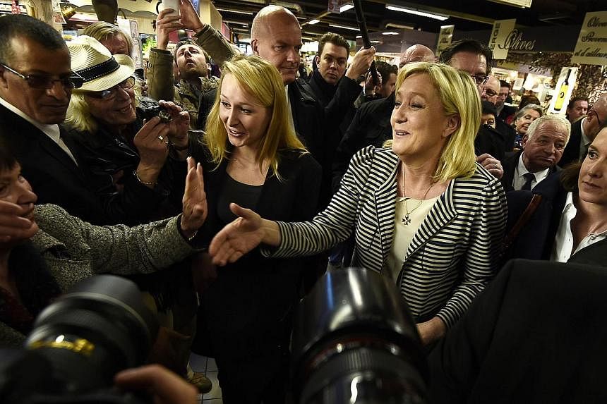 The president of the far-right National Front (FN) party, Ms Marine Le Pen (right), working the crowd on March 17, 2015, at a market in the southern French city of Avignon. Fear of immigration and anger about elite corruption have bolstered the FN - 