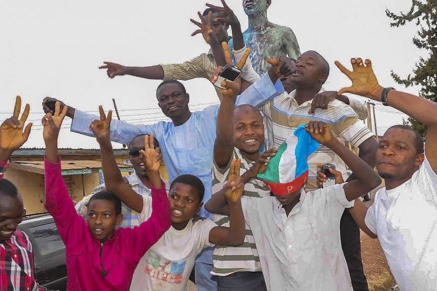 Nigerians celebrating the victory of Mr Muhammadu Buhari in Jos, Nigeria, on March 31, 2015, at the presidential election. -- PHOTO: EPA