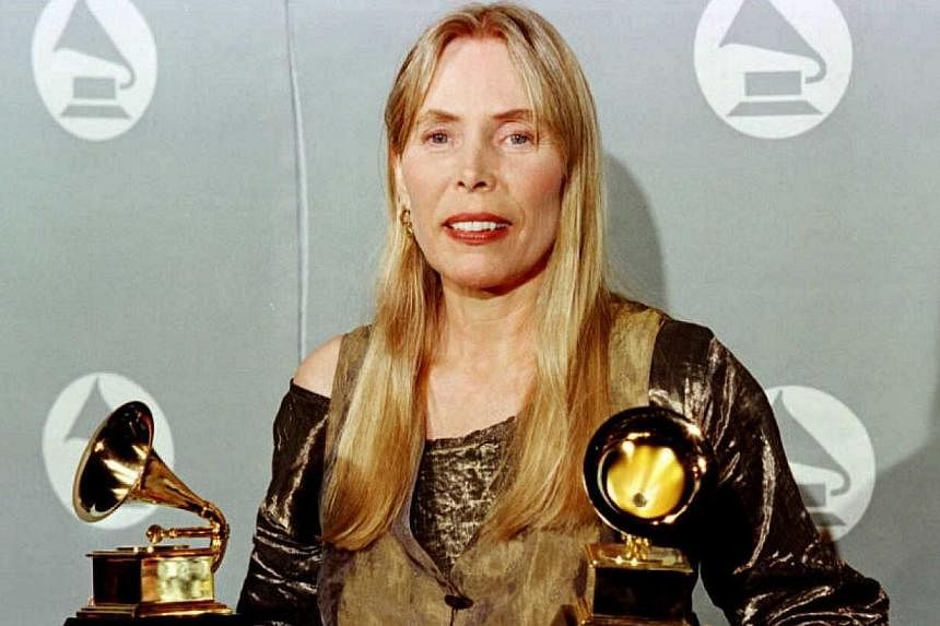 This February 28, 1996 file photo shows singer Joni Mitchell holding two Grammy Awards for Best Pop Album, "Turbulent Indigo," during the 38th Annual Grammy Awards in Los Angeles. -- PHOTO: AF