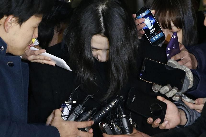 Cho Hyun Ah (centre), also known as Heather Cho, daughter of chairman of Korean Air Lines Cho Yang Ho, is surrounded by the media as she leaves the Seoul Western District Prosecutor's office&nbsp;on Dec 30, 2014. The Seoul High Court began hearing an