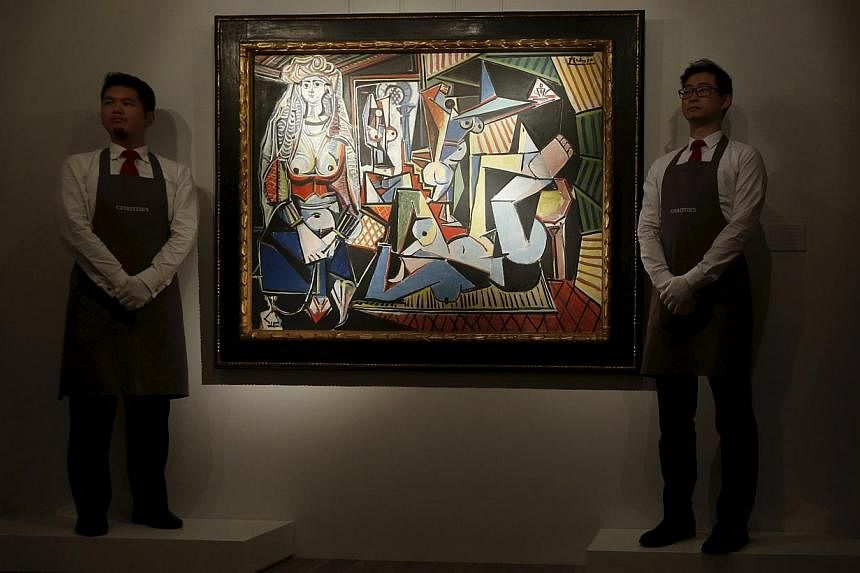 Staff at Christie's pose beside Les femmes d'Alger (Version 'O') by painter Pablo Picasso during a preview in Hong Kong on April 1, 2015. The masterpiece went on show for the first time in Hong Kong on Wednesday ahead of an auction where it is tipped