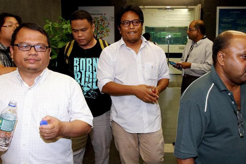 (Foreground, from left) The Malaysian Insider's features editor Zulkifli Sulong, Bahasa news editor Amin Shah Iskandar and managing editor Lionel Morais being led out of their office in Mutiara Damansara, Petaling Jaya, on Monday. The three of them w