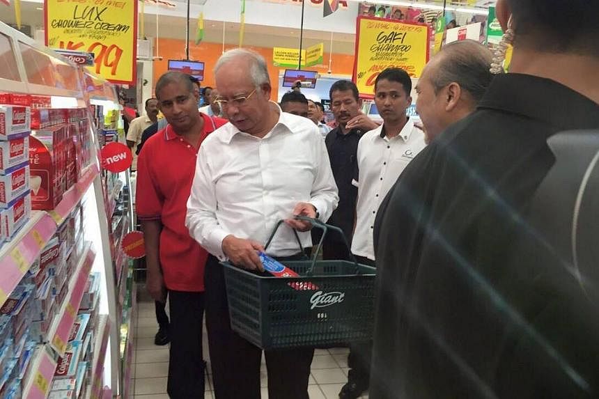Malaysian Prime Minister Najib Razak went shopping in a supermarket on the first day the country implemented a 6 per cent consumption tax aimed at plugging a leaky tax-collection system. -- PHOTO: NAJIB RAZAK'S FACEBOOK&nbsp;