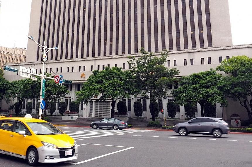 Cars pass by the Central Bank of the Republic of China (Taiwan) in Taipei, Taiwan on March 31, 2015. China welcomes Taiwan's decision to apply to join the Beijing-led Asian Infrastructure Investment Bank (AIIB) as long as the self-ruled island uses a