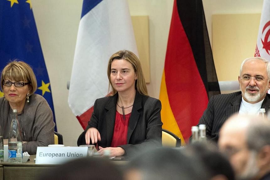 (From left) European Union Political Director Helga Schmid, European Union High Representative Federica Mogherini and Iranian Foreign Minister Javad Zarif wait with others for a meeting with officials from the P5+1, the European Union and Iran in Lau