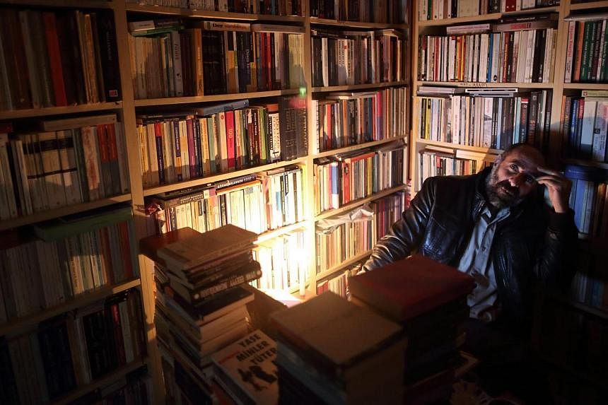 A bookseller sits in his dark shop after a major power cut around Taksim Square in Istanbul, Turkey, on March 31, 2015.&nbsp;The causes of Turkey's biggest power cut in over 15 years that deprived most of the country of electricity remained shrouded 