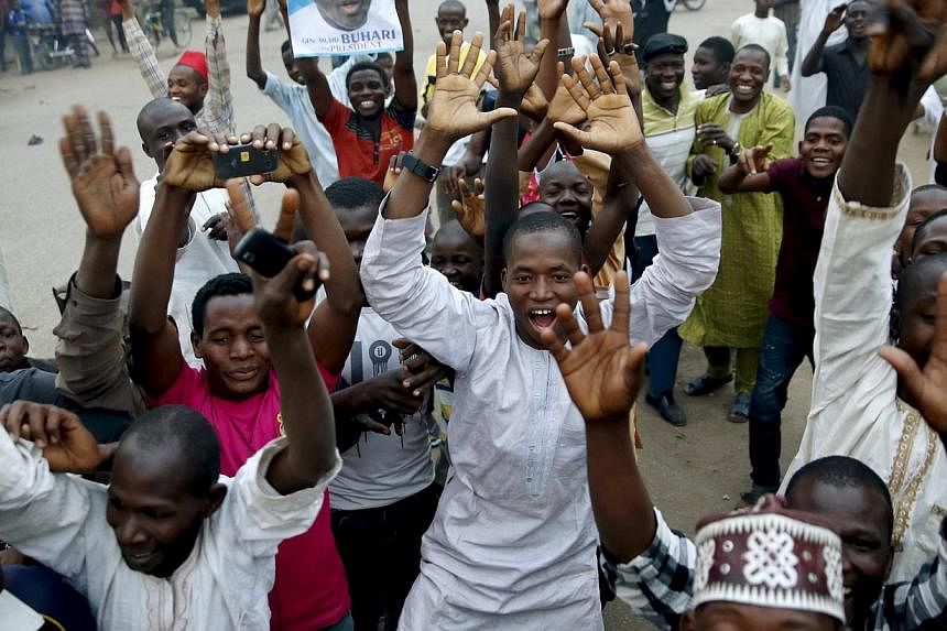 Supporters of the presidential candidate Muhammadu Buhari and his All Progressive Congress (APC) party celebrate in Kano on Tuesday. Three after Buhari became the first Nigerian to oust a president through the ballot box, putting him in charge of Afr