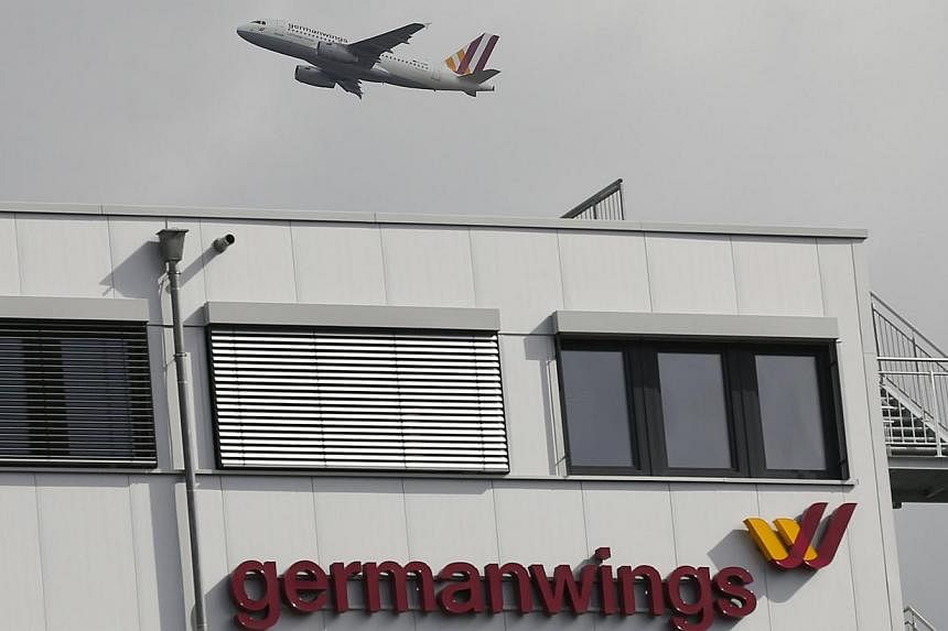 A Germanwings aircraft takes off from Cologne-Bonn airport in front of dark clouds on March 27. -- PHOTO: REUTERS