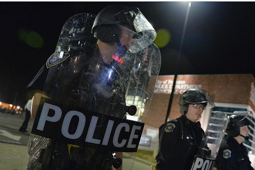 Ferguson police were sharply criticised for their heavy-handed actions in August during unrest triggered by the fatal shooting of an unarmed black teenager by a white officer. -- PHOTO: AFP