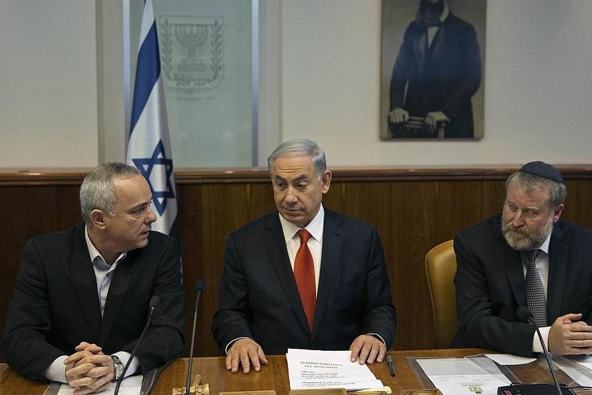 (From left) Israel's Strategic Affairs Minister Yuval Steinitz, Prime Minister Benjamin Netanyahu and Cabinet Secretary Avichai Mandelblit at a weekly cabinet meeting in Jerusalem on&nbsp;Feb 22, 2015. Steinitz said on Thursday, April 2, that all opt