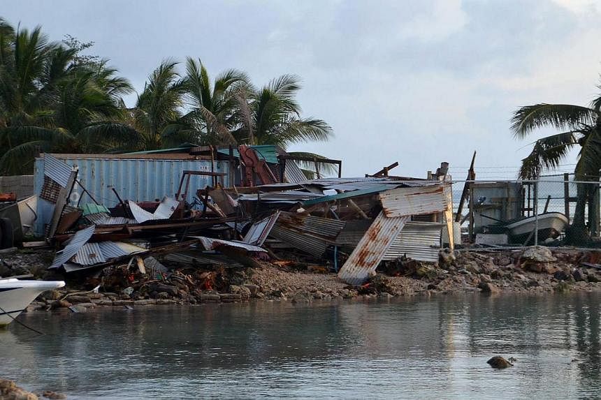This picture taken on March 29, 2015, shows structures damaged during storms brought on by Super Typhoon Maysak near the village of Mwan, on the island of Weno, in the Micronesian state of Chuuk. -- PHOTO: AFP &nbsp;