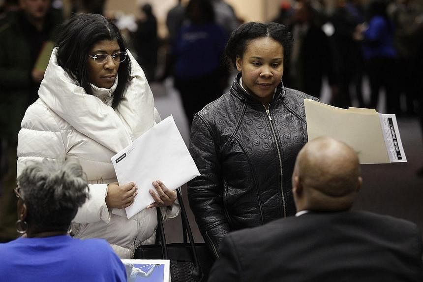 People attend a job fair in Detroit, Michigan, in this file photo taken on March 1, 2014. -- PHOTO: REUTERS