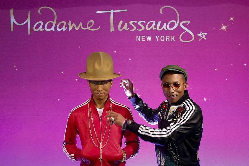 Musician Pharrell Williams poses next to his wax double at Madame Tussauds in New York April 1, 2015. -- PHOTO: REUTERS