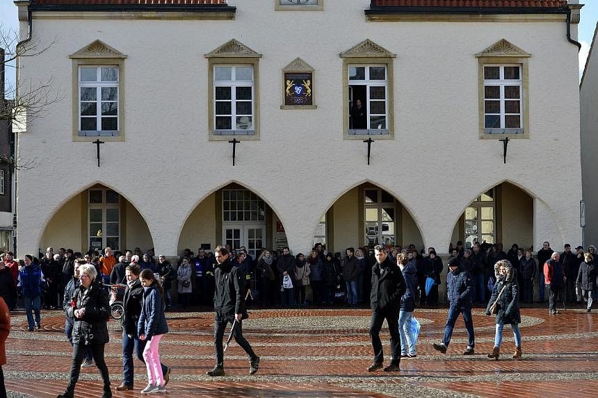 People gather for a mourning service in front of the church St Sixtus in Haltern am See, western Germany on April 1, 2015, from where some of the Germanwings plane crash victims came. The small German town of Haltern am See on Wednesday held an emoti