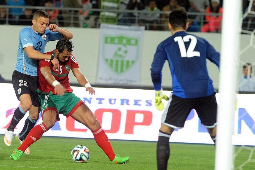 Morocco's Mzehdi Ben Attia (centre) fights for the ball against Uruguay's Martin Silva (left) as Moroccan goalkeeper Mounir Mohamdi looks on during a friendly football match in Agadir, Morocco, on March 28, 2015.&nbsp;The Court of Arbitration for Spo