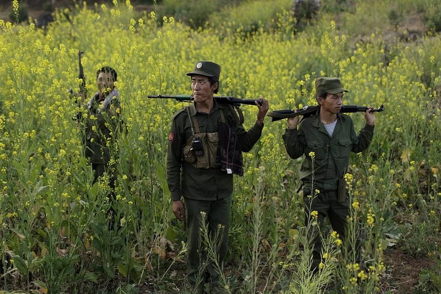 Rebel soldiers of Myanmar National Democratic Alliance Army (MNDAA) patrol near a military base in Kokang region on March 10, 2015.&nbsp;Myanmar has accepted responsibility and apologised for bombs dropped on Chinese territory last month during clash