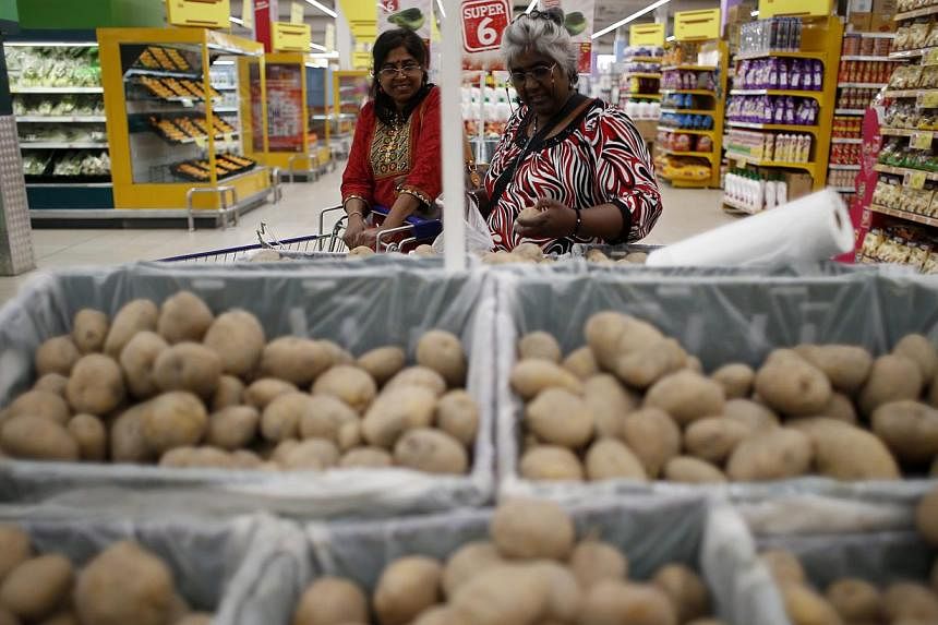 Two women shopping in a supermarket at Shah Alam, outside Kuala Lumpur, &nbsp;on April 1, 2015. Malaysia joined the ranks of 160 other countries globally in embracing the Goods and Services Tax (GST). Under the new GST, consumers will be charged a fl