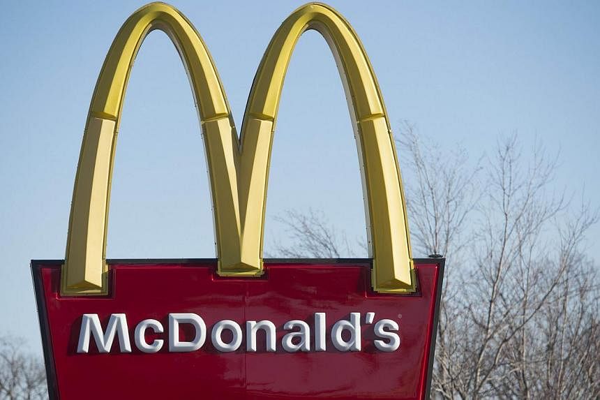 A McDonalds fast-food restaurant in Alexandria, Virginia.&nbsp;McDonald's announced Wednesday that it would increase wages for 90,000 employees in company-owned restaurants in the United States, as well as offering them paid time-off. -- PHOTO: AFP