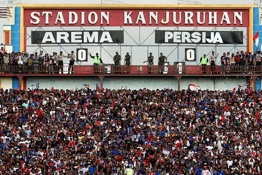 The Aremania, as fans of Indonesian Super League (ISL) football club Arema Malang are called, showing their support during an ISL match against Persija on Oct 11, 2009, at the Kanjuruhan Stadium in Malang, Indonesia. The league has been plagued by pr