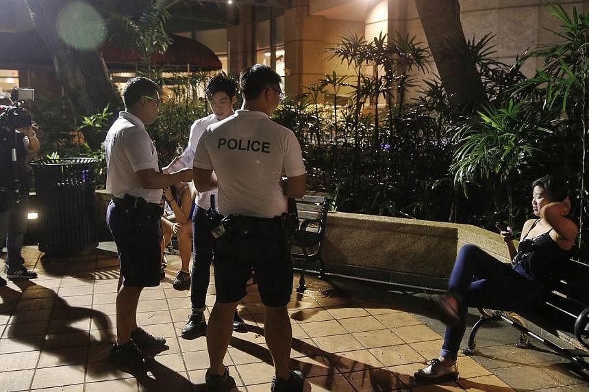 Police officers handing out pamphlets at Robertson Quay on Wednesday. The Ministry of Home Affairs has welcomed initiatives by the liquor industry in support of the new alcohol law which kicked in on Wednesday. -- ST PHOTO: KEVIN LIM&nbsp;
