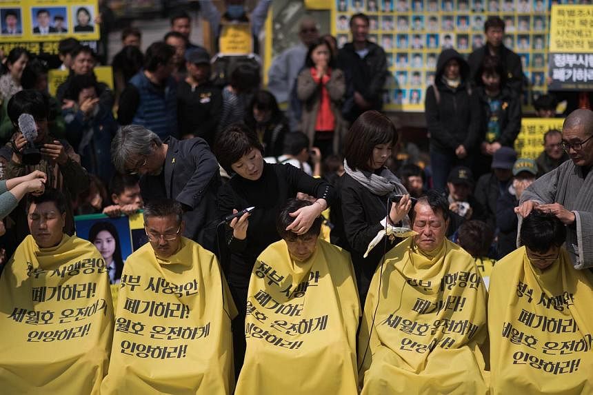 Relatives of victims of the Sewol ferry accident have their heads shaved during a protest ahead of the anniversary of the disaster, in Seoul on April 2, 2015.&nbsp;Around 50 mothers and fathers of victims of the disaster had their heads shaved to pus