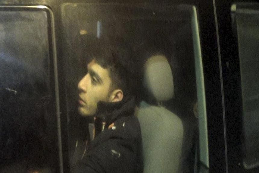 A man beleived to be a British citizen looks on as he is driven away from a Turkish military station on April 2, 2015, in Hatay, on the Turkish border with Syria. Nine Britons arrested by Turkish authorities trying to cross into Syria were all member
