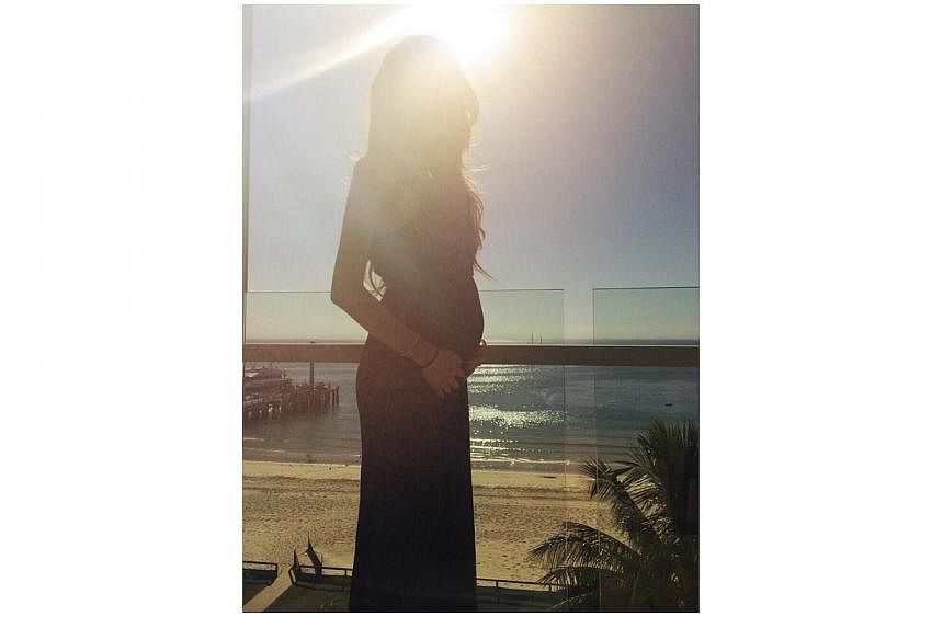 In another photo, a visibly pregnant Quinlivan is on her own on a balcony.&nbsp;-- PHOTO: FACEBOOK