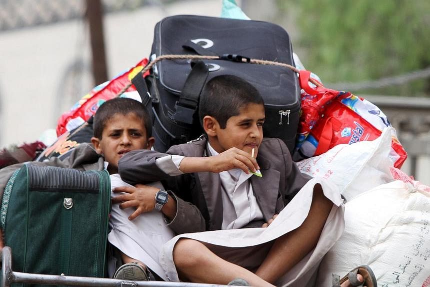 Boys fleeing Sanaa with their family and belongings, fearing renewed air strikes. The stage seems set for greater foreign military intervention.