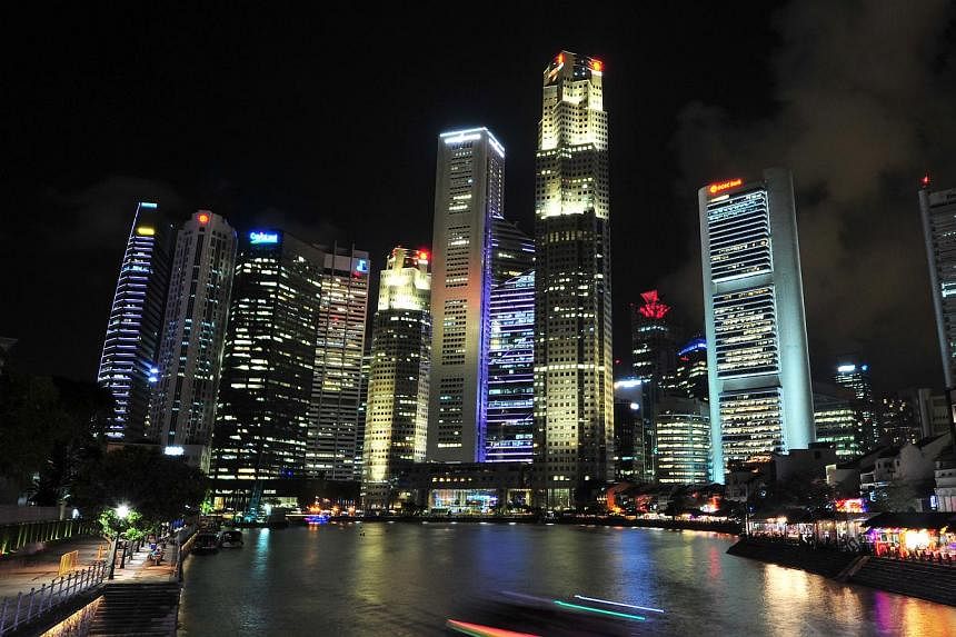 The Singapore skyline at night. The city is a far cry from the impoverished swampy island it was 50 years ago. -- PHOTO: ST FILE