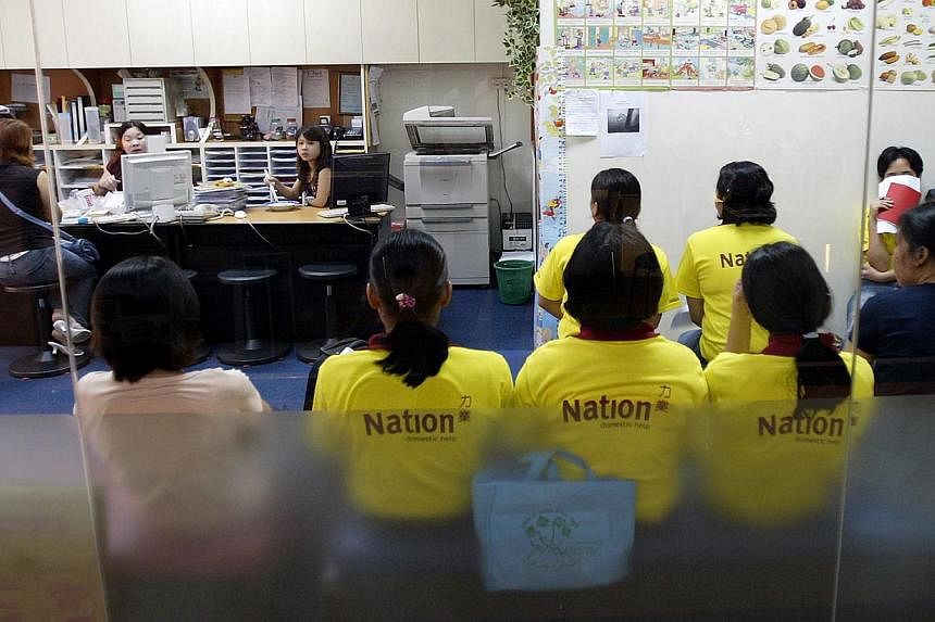 Maids at a maid agency in Hougang Green mall. -- PHOTO: ST FILE