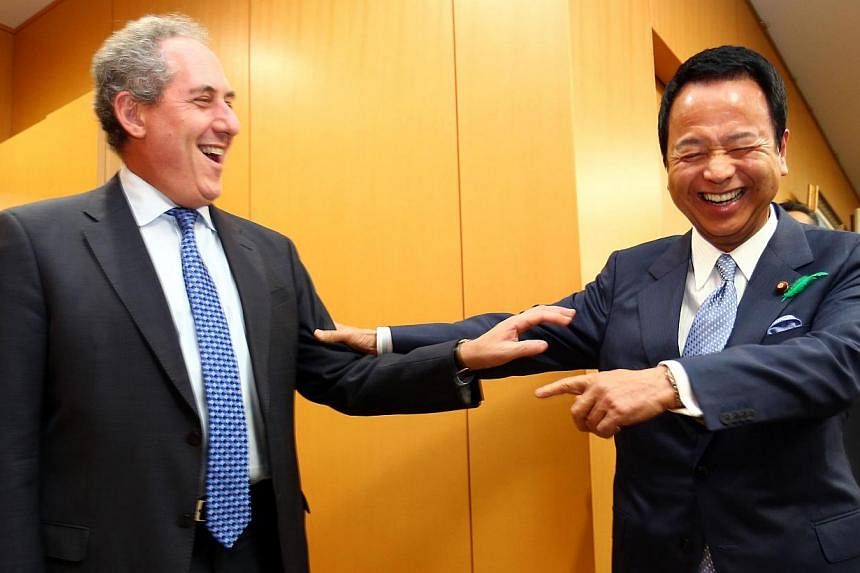 US Trade Representative Michael Froman (left) and Japan's Economy Minister Akira Amari exchanging greetings before talks over deadlocked TPP negotiations, which involve 12 countries.