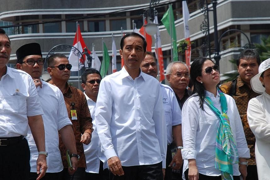 The writer, Chief of Staff Luhut Pandjaitan (far left), accompanying Indonesian President Joko Widodo (centre), Coordinating Minister for Human Development and Culture Puan Maharani (front row, second from right), Foreign Minister Retno Marsudi (far 