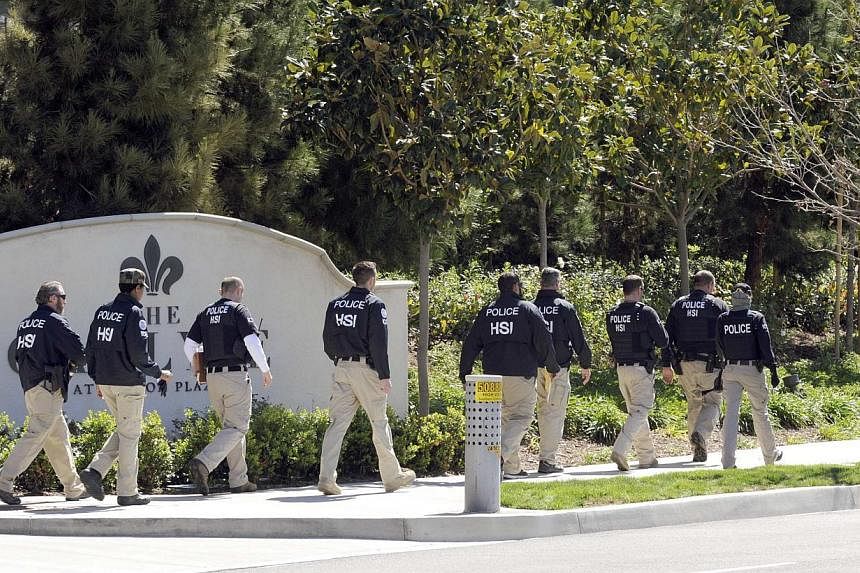 Federal agents walking past a location of a suspected "baby tourism" operation, in Irvine, California on March 3, 2015. -- PHOTO: REUTERS