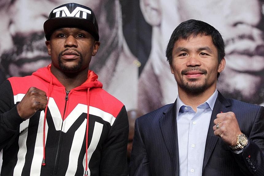 WBC/WBA welterweight champion Floyd Mayweather (left) and WBO welterweight champion Manny Pacquiao pose during a news conference at the KA Theatre at MGM Grand Hotel &amp; Casino on April 29, 2015, in Las Vegas, Nevada. -- PHOTO: AFP&nbsp;