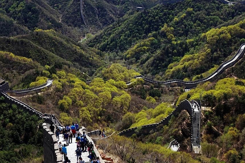 Chinese tourists climb the Great Wall at Badaling, north of Beijing, on April 22, 2015. The 21 top Chinese tourist sites include the Badaling sector of the Great Wall outside of Beijing, the old summer residence of the Qing emperors at Chengde and th
