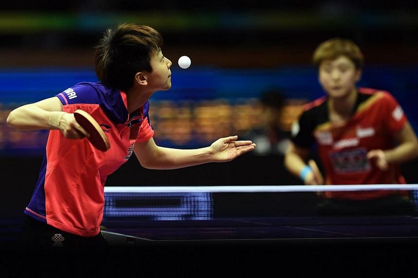 Mu Zi of China serving against Feng Tianwei of Singapore at the World Table Tennis Championships at the Suzhou International Expo Centre in Suzhou on May 1, 2015. -- PHOTO: AFP&nbsp;