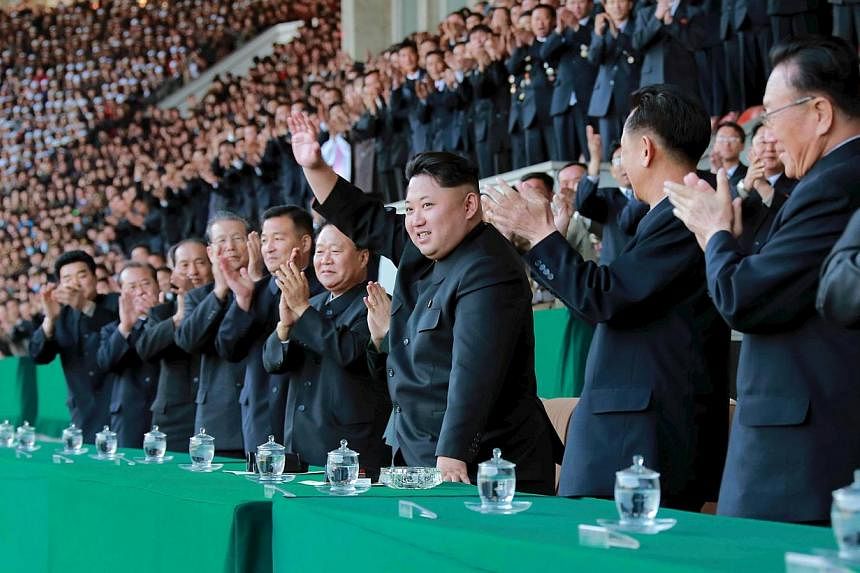 North Korean leader Kim Jong Un (centre) gestures during a men's football match in an undated photo released on April 14, 2015. North Korean diplomats on Thursday walked out of a UN conference on human rights in protest at the testimonies from three 