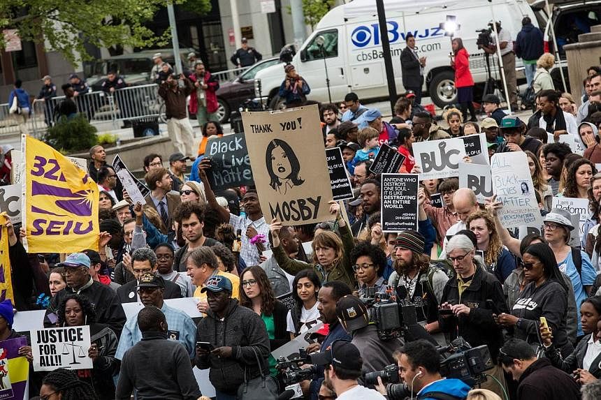 Protesters marching through the streets on May 1, 2015, in Baltimore, Maryland, despite the announcement that charges would be filed against Baltimore police officers in the death of Freddie Gray. -- PHOTO: AFP &nbsp;