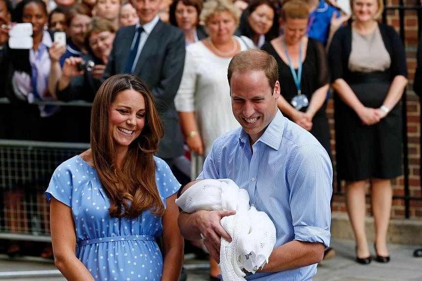 Britain's Prince William and Catherine, Duchess of Cambridge show their new-born baby boy, Prince George of Cambridge, to the world's media outside the Lindo Wing of St Mary's Hospital in London on July 23, 2013. -- PHOTO: AFP